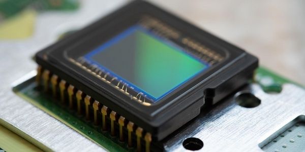 Close-up of a semiconductor sensor package mounted on a circuit board