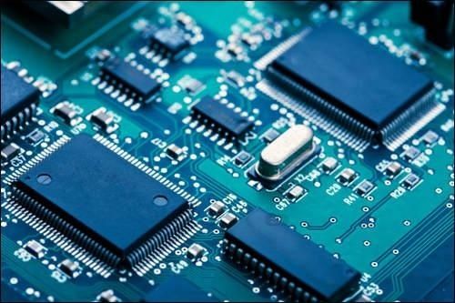 Close-up of microchips and components on a blue circuit board