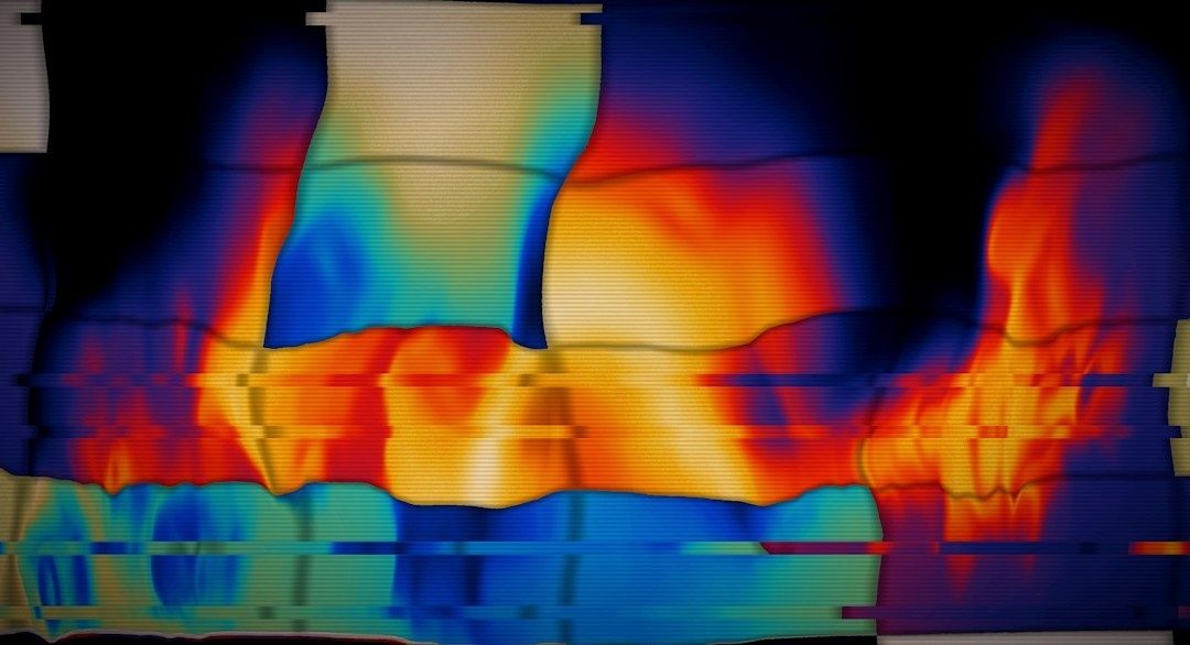 False-color thermal image showing heat concentrated across a device surface