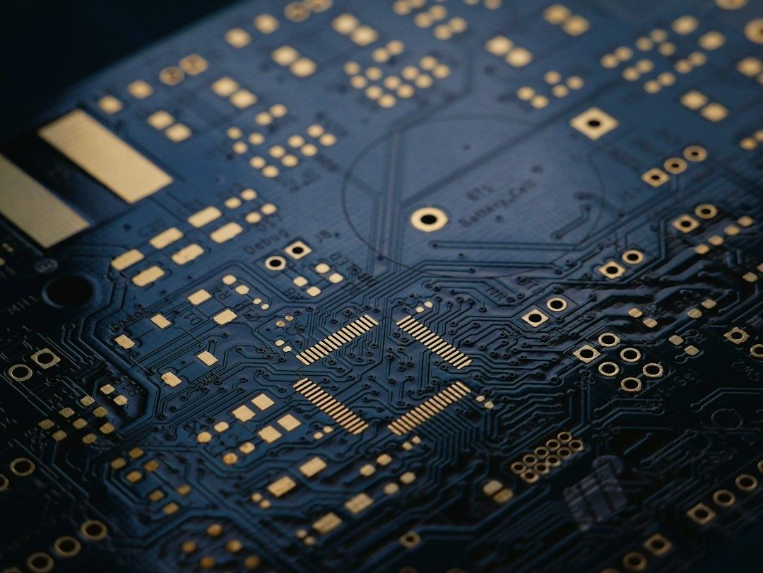 Macro view of a dark silicon circuit board with gold contacts and traces